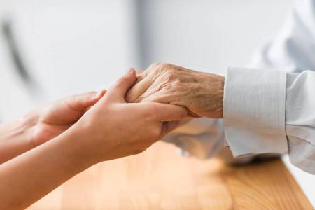 Jory Employment: nurse-holding-senior-man-s-hands-comfor